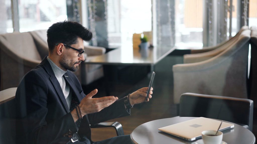 A wealthy hotel guest sits down to have a cup of coffee